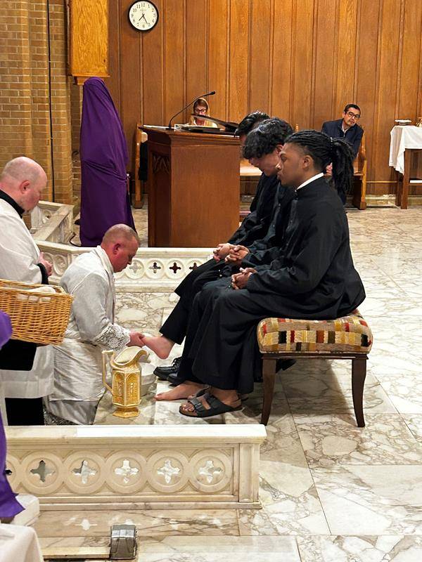 Father Casey Coleman washes the feet of parishioners of Our Lady of Grace Church in Greensboro.