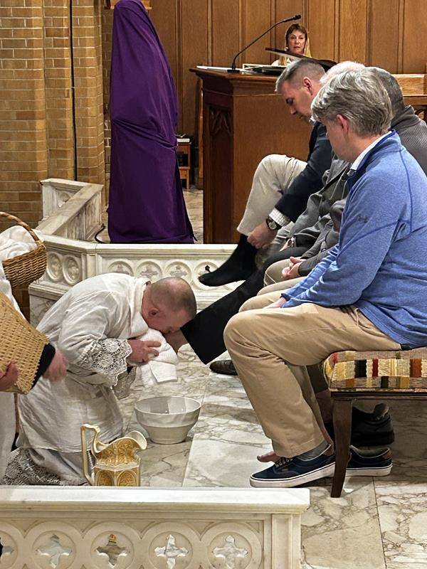 Father Casey Coleman washes the feet of parishioners of Our Lady of Grace Church in Greensboro.