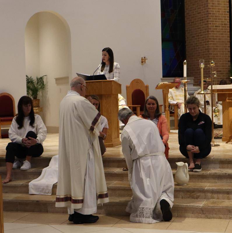 Father Mark Lawlor washes the feet of his parishioners at St. Therese Church in Mooresville.