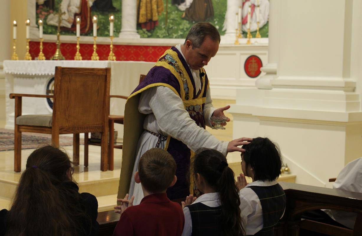 Students at St. Ann School receive ashes. 