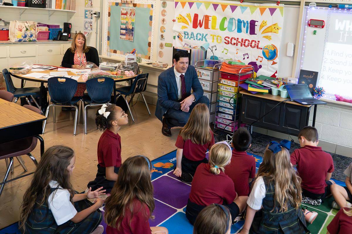 Dr. Greg Monroe, Superintendent of schools, visits with students at St. Ann School in Charlotte on the first day of school.