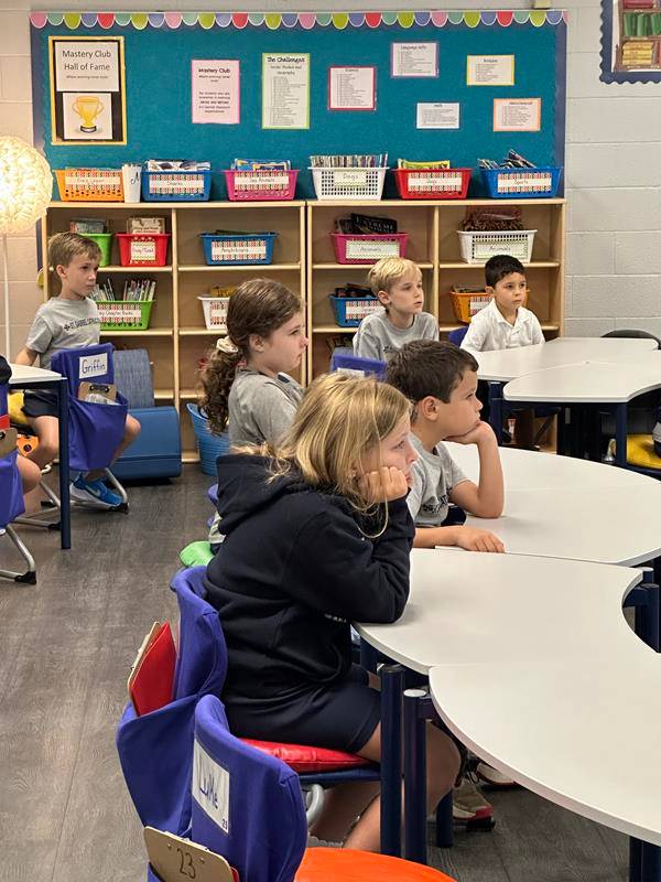 Students at St. Gabriel School in Charlotte watch a message from Bishop Martin on the first day of school. 