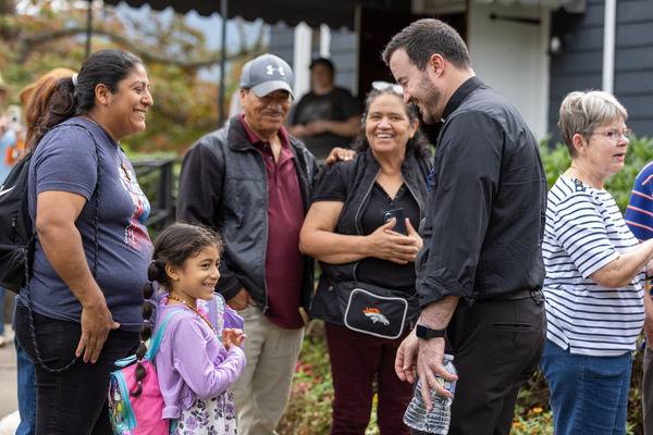 Father Miguel Sanchez, Bishop Martin's priest-secretary, also met with and blessed parishioners. (Gabriel Swinney)
