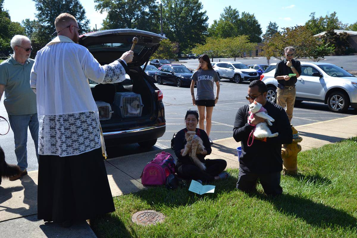 Father Noah Carter blesses animals at Holy Cross Church in Kernersville.