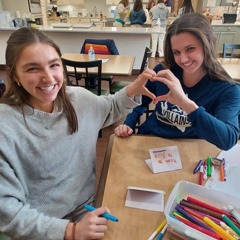Bishop McGuinness High School student baked homemade cookies, cleaned around the house, chalked the walk, and made welcome cards for SECU Family House of Winston Salem. 