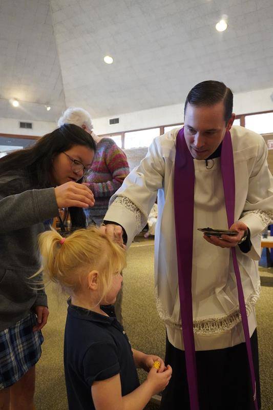 Students at Asheville Catholic School receive ashes for the start of Lent. 