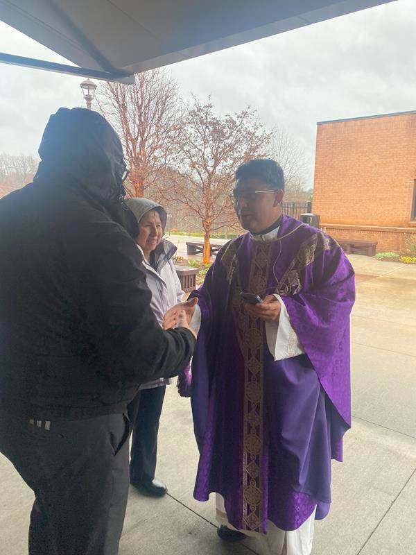 Father Huver E. Navarro Vigo greets parishioners after the 9 a.m. Mass at St. Therese in Mooresville. 