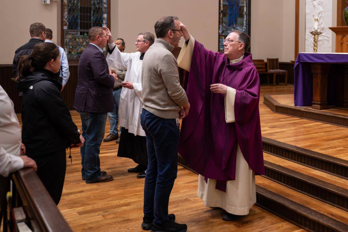 People receive ashes for the start of Lent at St. Peter Church in Charlotte. 