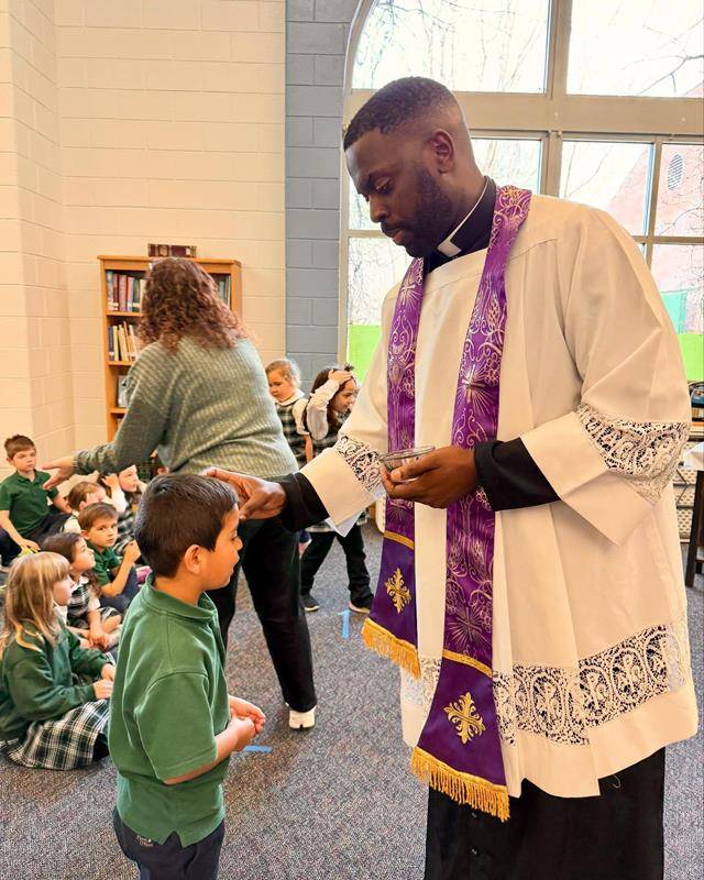 A St. Mark School student recieves ashes on Ash Wednesday.