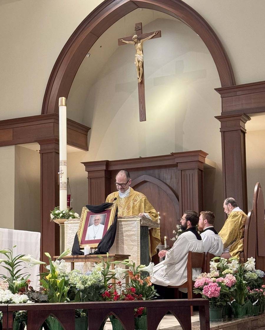 At Mass at St. Mark Church in Huntersville on Monday, Father John Putnam reflected on the pope’s ministry of service to the Church. (Photo by Amy Burger)