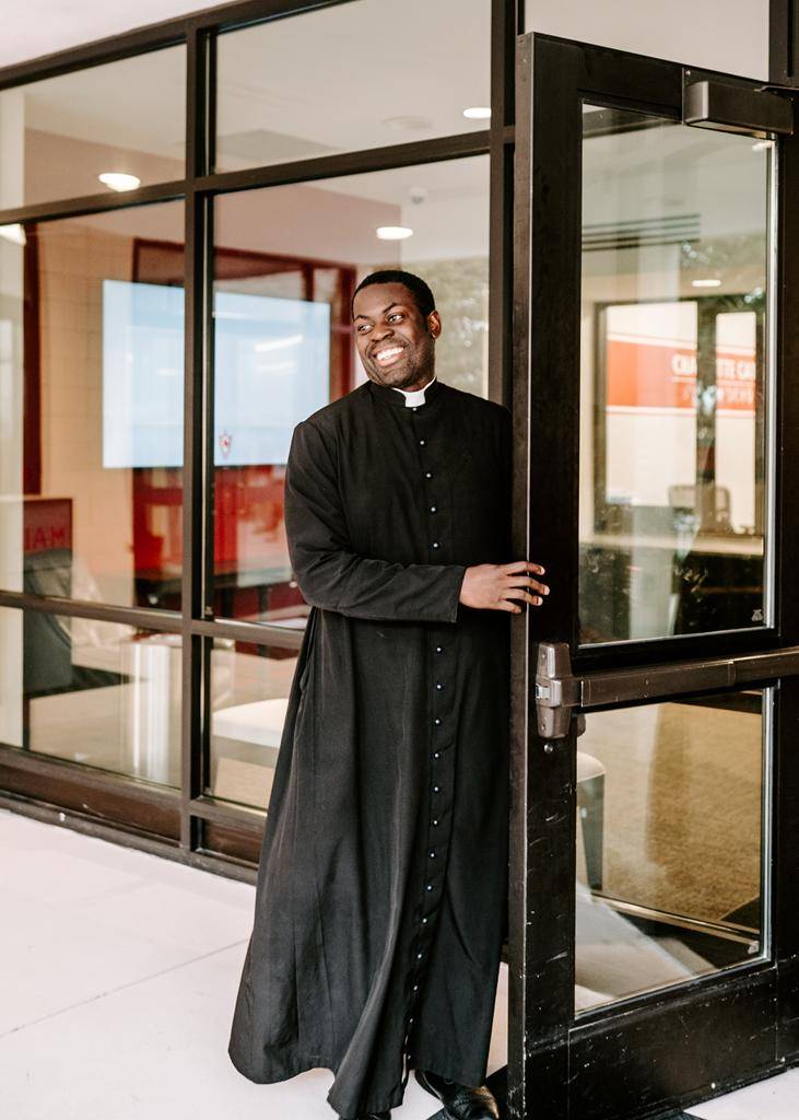 Father Chinonso Nnebe-Agumadu, chaplain at Charlotte Catholic, welcomes students to the school. 