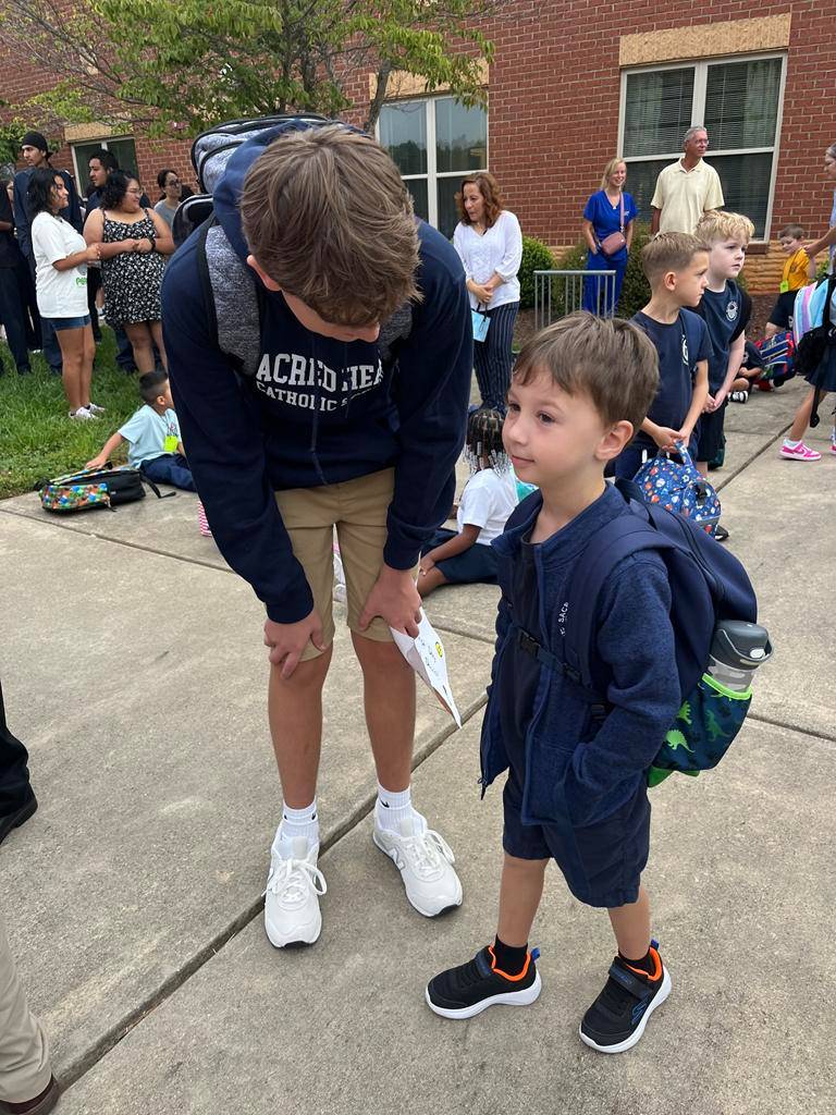 At Sacred Heart School in Salisbury, kindergarten students walk hand-in-hand into school with their 8th grade buddies. 