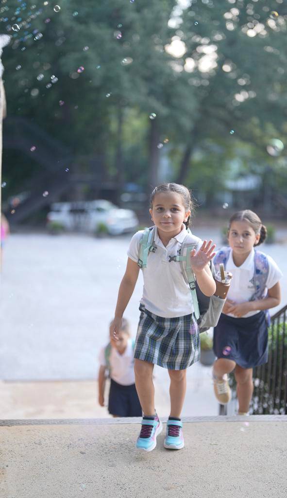 Smiles and waves from St. Patrick School in Charlotte students excited for the school year to start. 