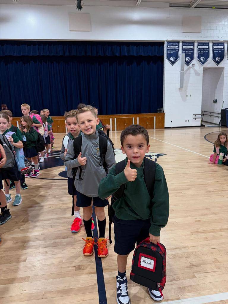 Students smile on the first day of school at St. Mark School in Huntersville. 