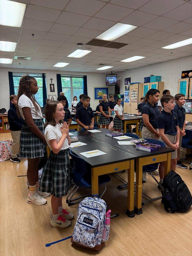 Students smile on the first day of school at St. Mark School in Huntersville. 