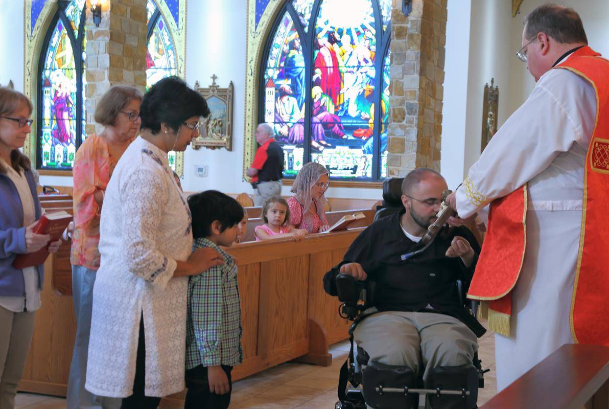 FOREST CITY — Veneration of the Cross and outdoor Stations of the Cross by Spanish Community on Good Friday at Immaculate Conception. (By Giuliana Polinari Riley)
