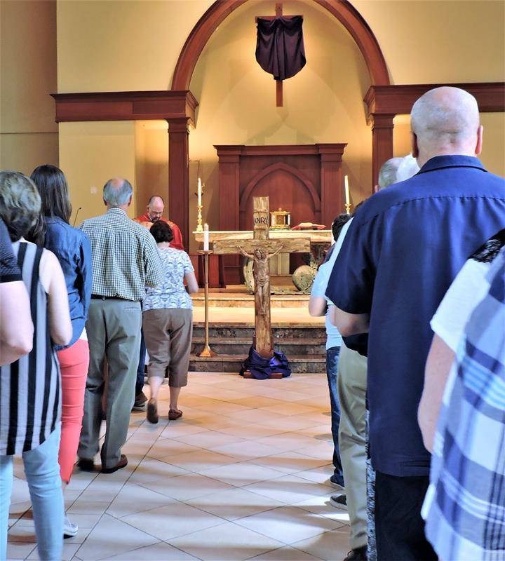 HUNTERSVILLE — Parishioners prayed the Stations of the Cross, then the Passion and then the Divine Mercy and Veneration of the Cross. (By Amy Burger) 
