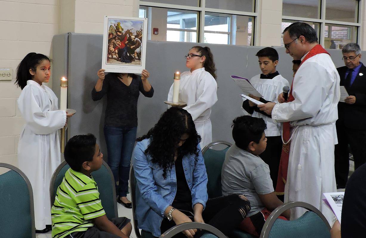 HUNTERSVILLE — Parishioners prayed the Stations of the Cross, then the Passion and then the Divine Mercy and Veneration of the Cross. (By Amy Burger) 