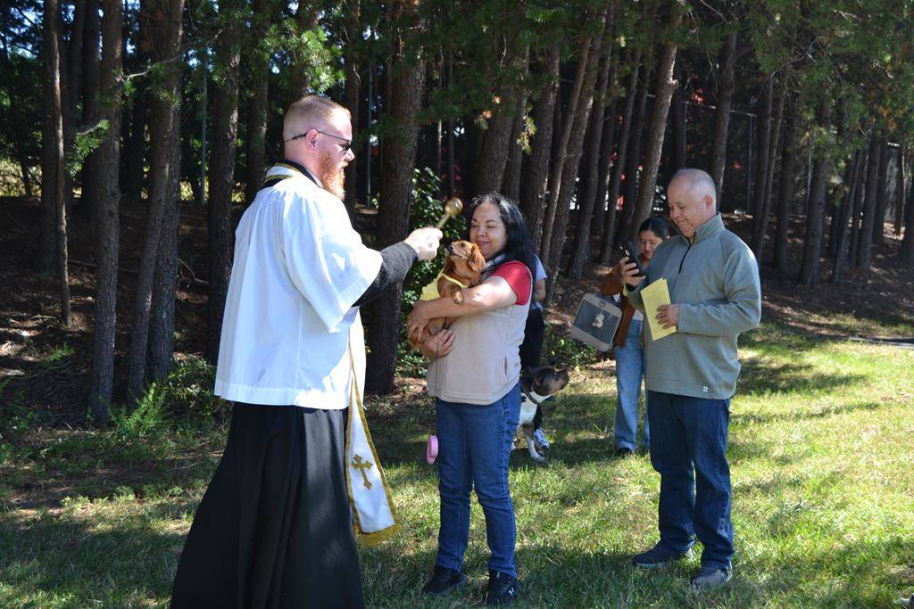 Father Noah Carter blesses animals at Holy Cross Church in Kernersville. 