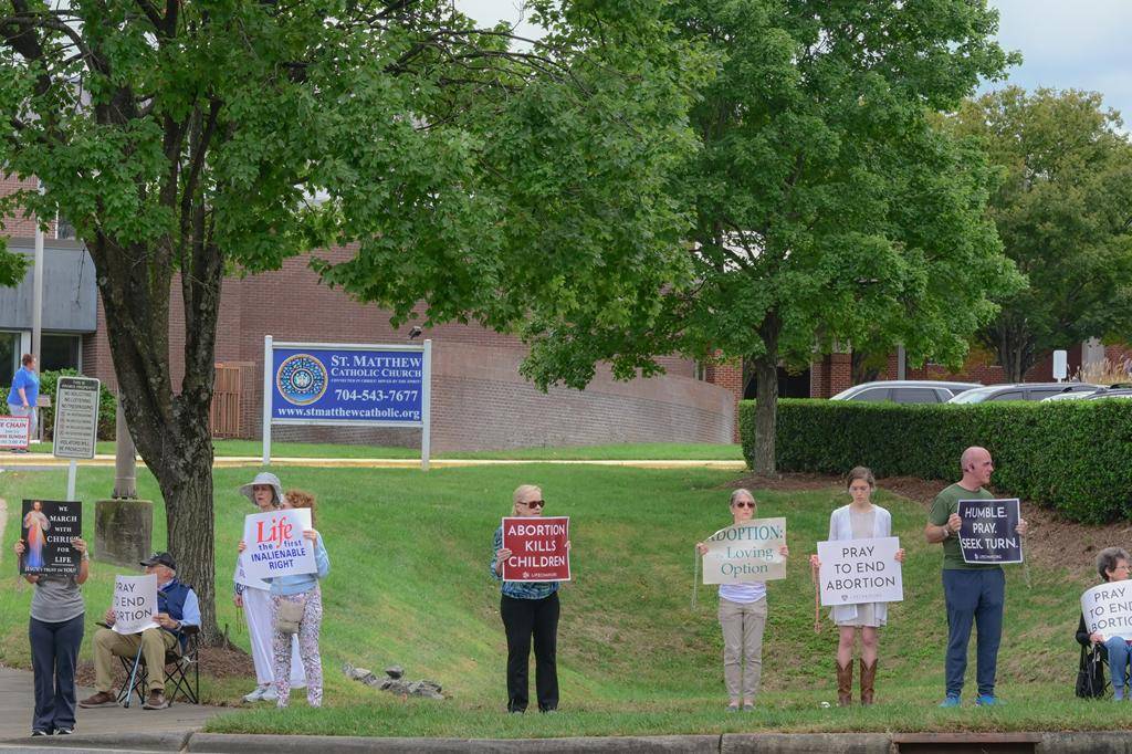Faithful gathered in south Charlotte with Father Cahill, FatherKramer and Deacon Joe Becker to pray for life near St. Matthew Church. 